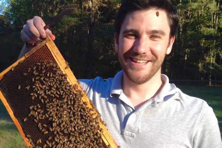 Scientist James Withrow with tray from bee hive